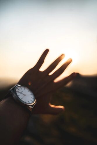 Looking at a watch during sunset